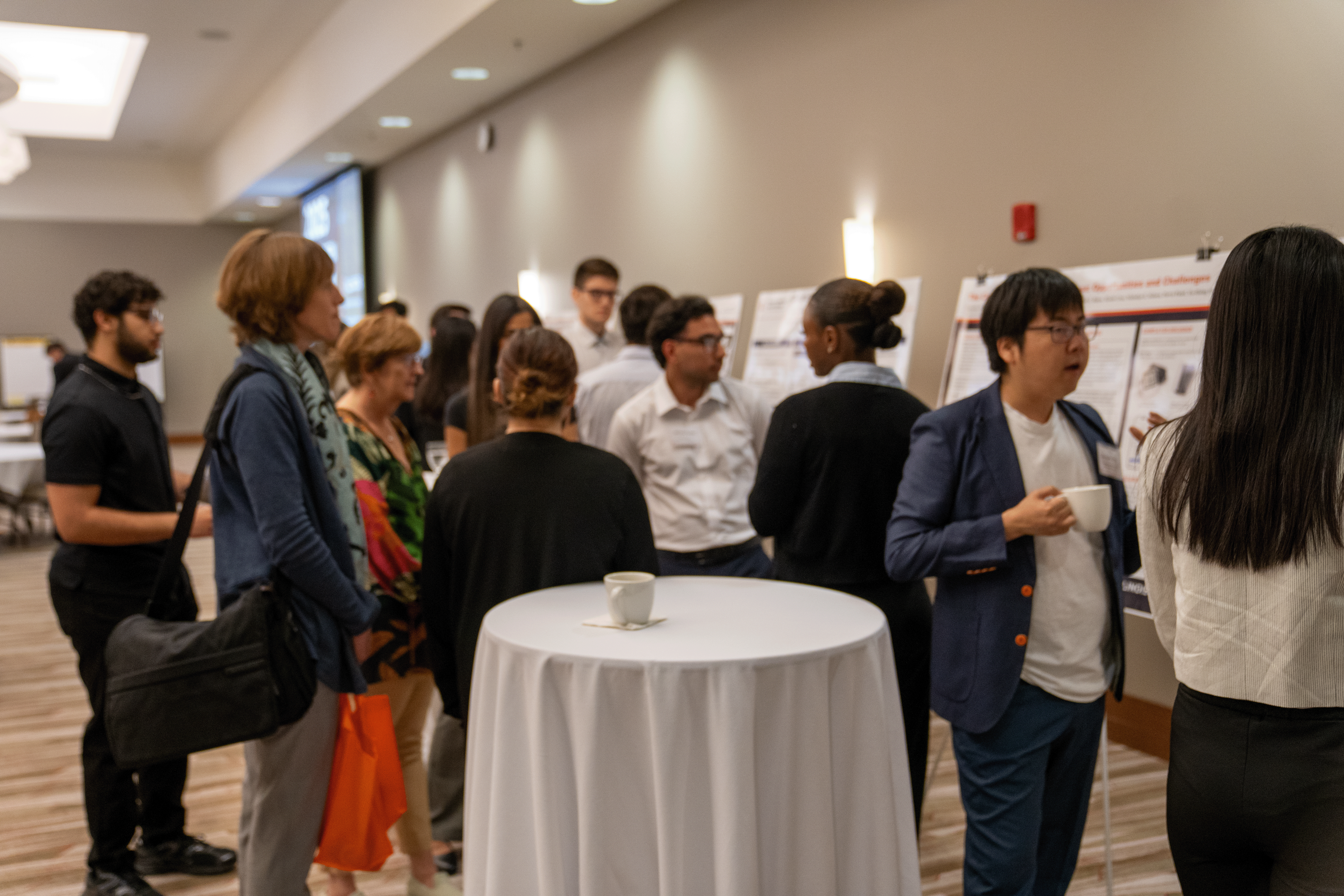 event attendees mingle around poster presentations