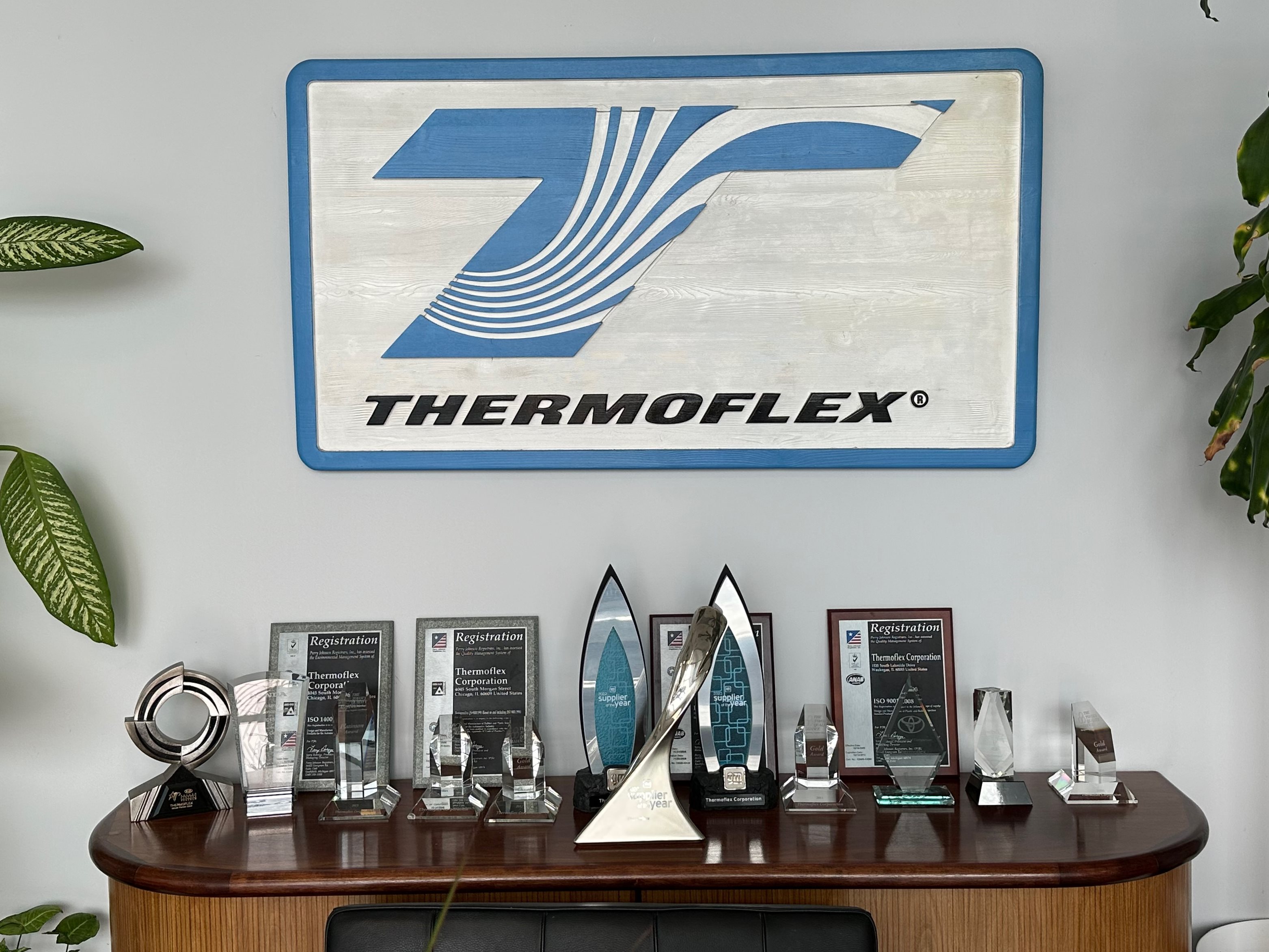thermoflex logo on the wall above awards