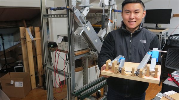 Michael Liao demonstrates his supension system for a solar-powered vehicle, created with an REU grant.