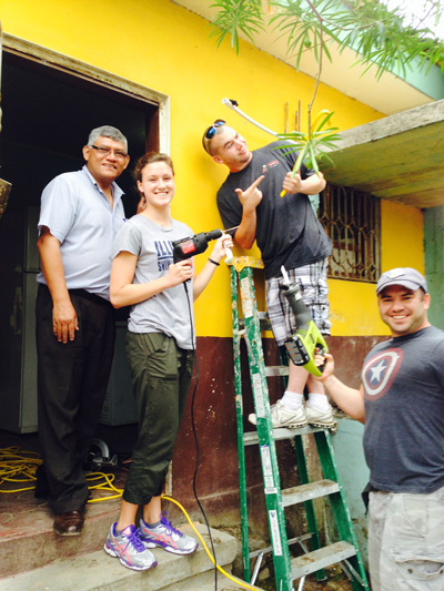 Mary Beth and some of the other members of her team begin bringing the system indoors by drilling a hole through the school's wall.