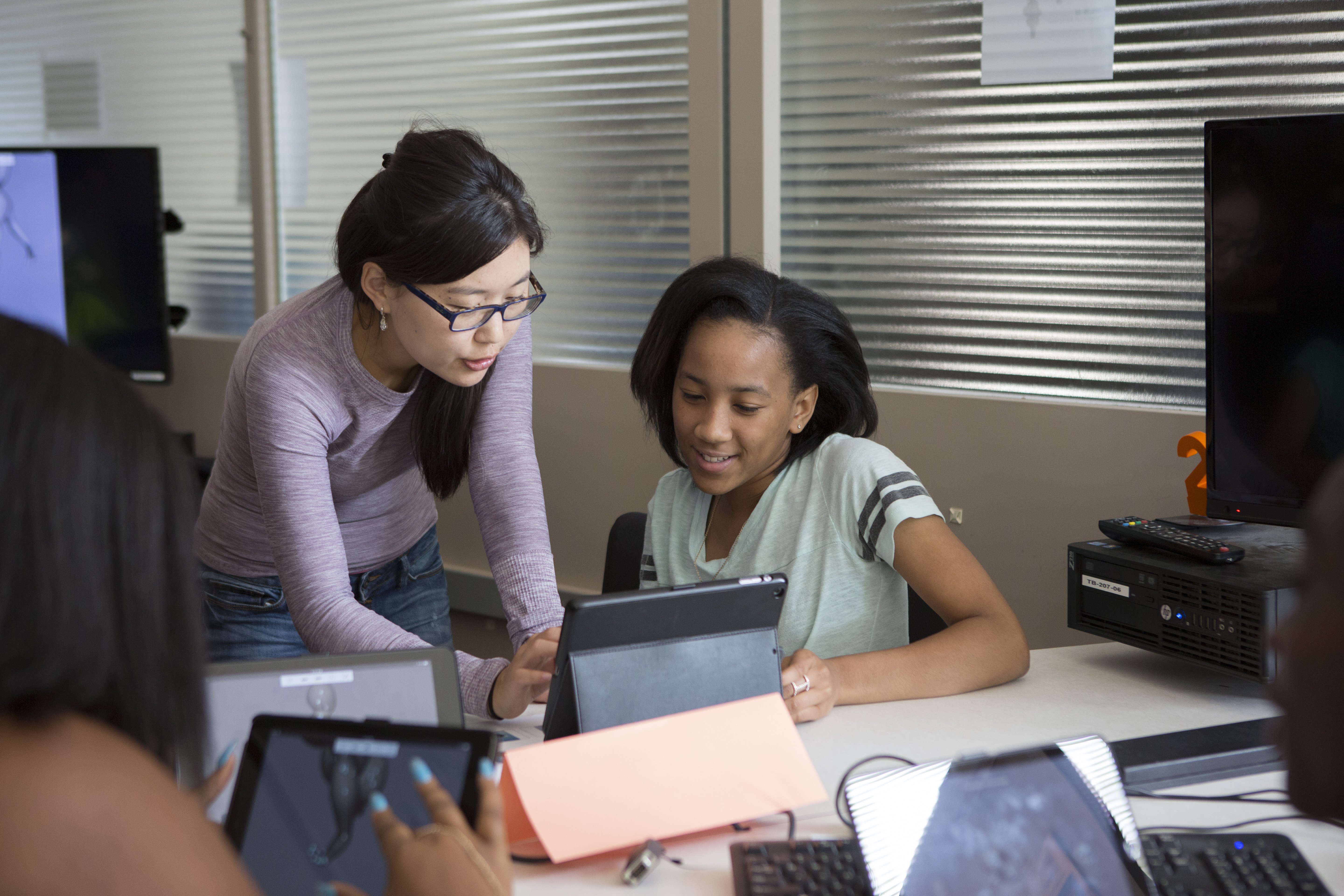 Product Design Lab T.A. and ISE graduate student Baigalmaa (Joanna) Batmunkh (center) assists 9th grade Alexa Stallworth.