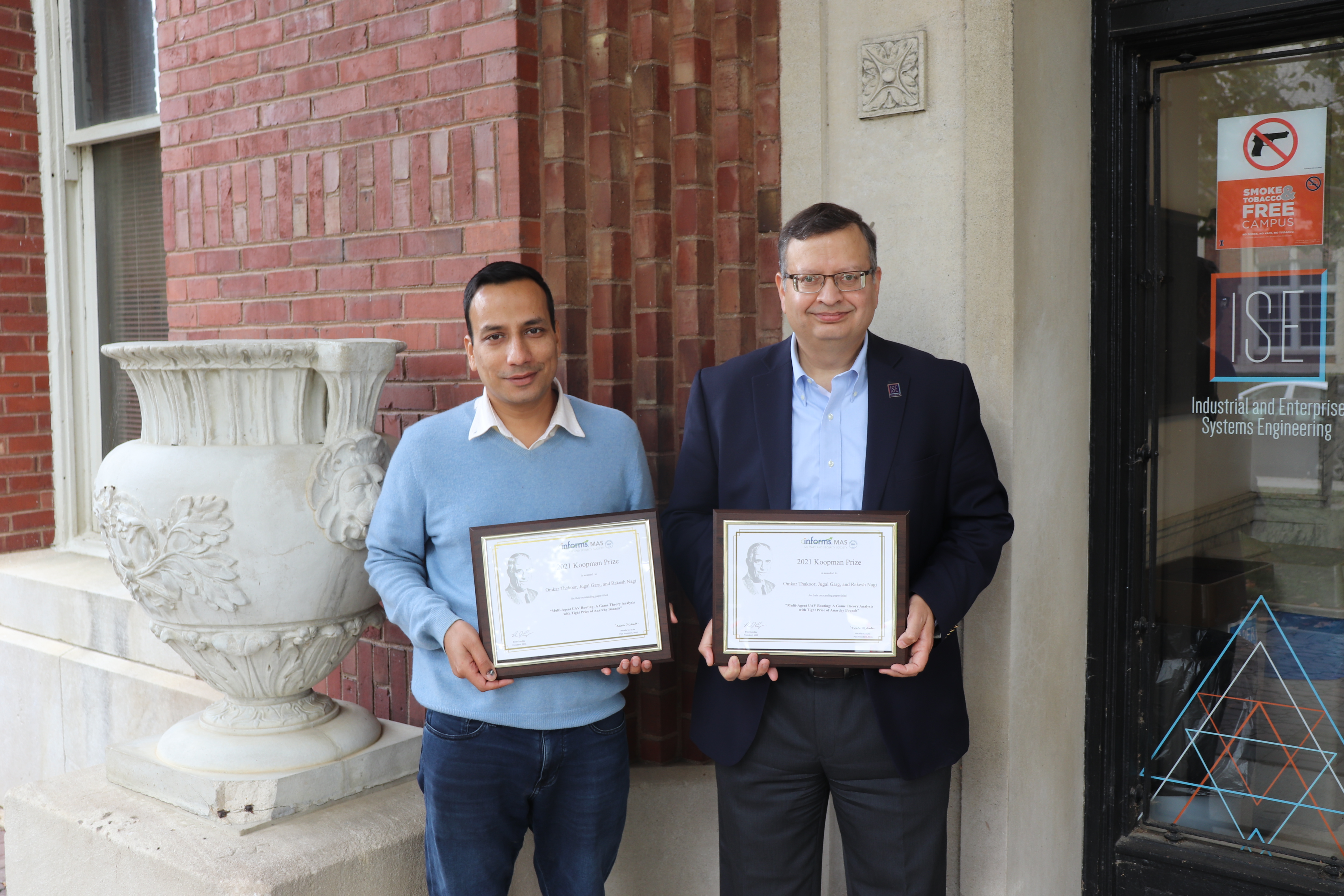 Professors Jugal Garg and Rakesh Nagi with the INFORMS Koopman Prize.